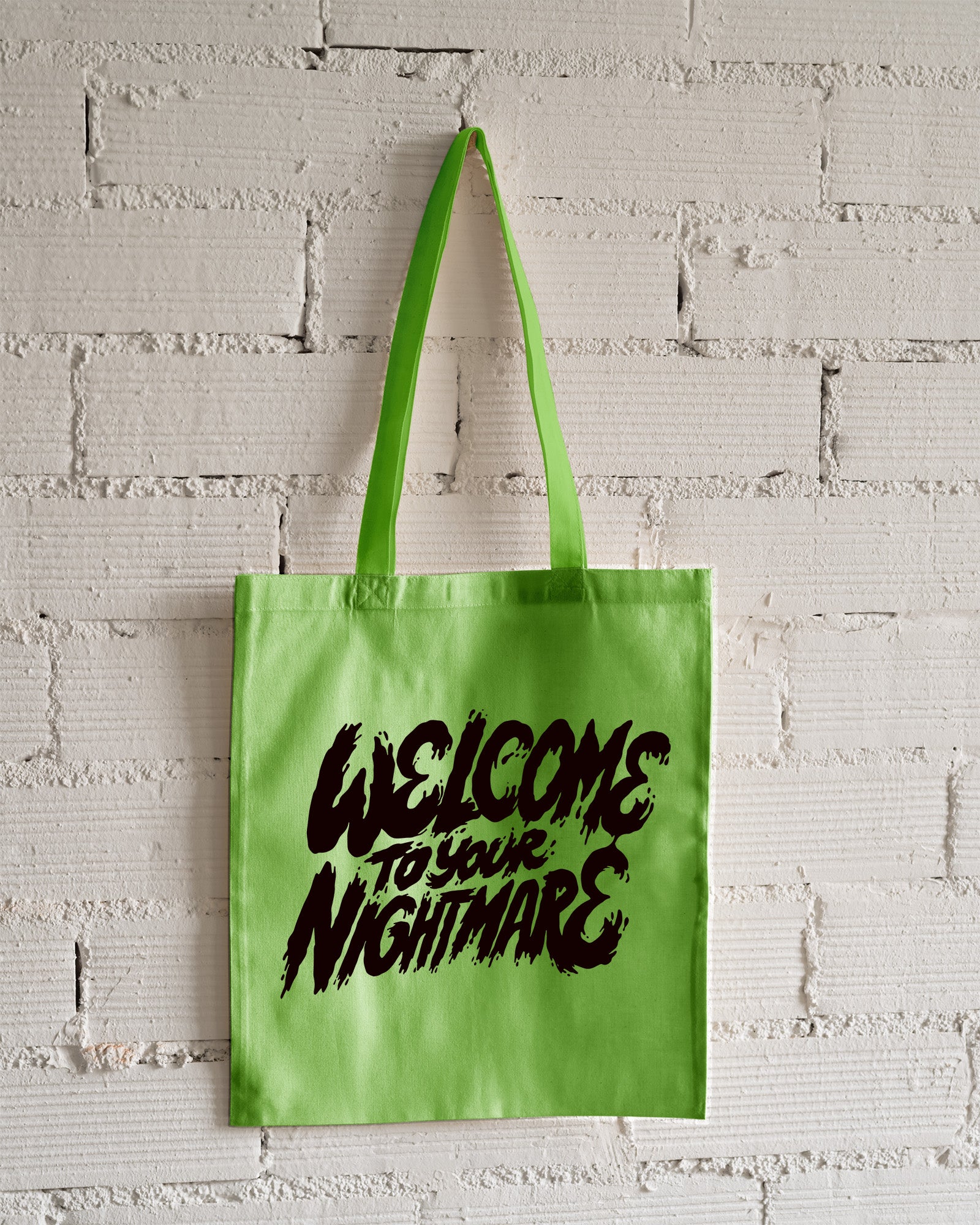 Lime Green tote bag featuring black text that reads Welcome to Your Nightmare in a horror-style font.